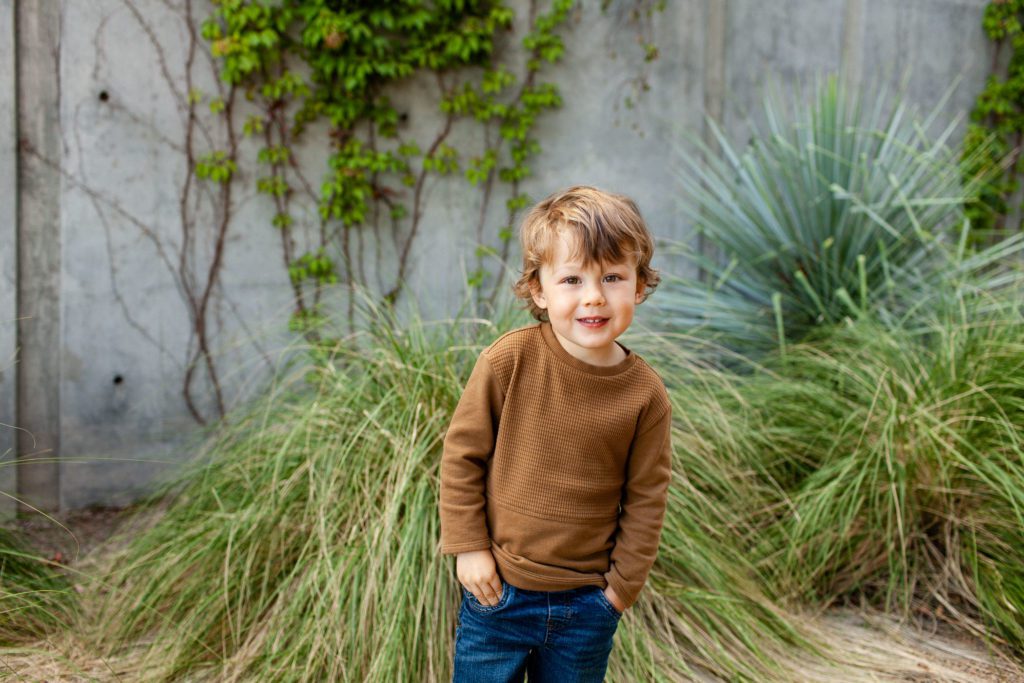 Modern outdoor spring portraits with toddler boy. Photography location at University of Arizona by Fletcher and Co