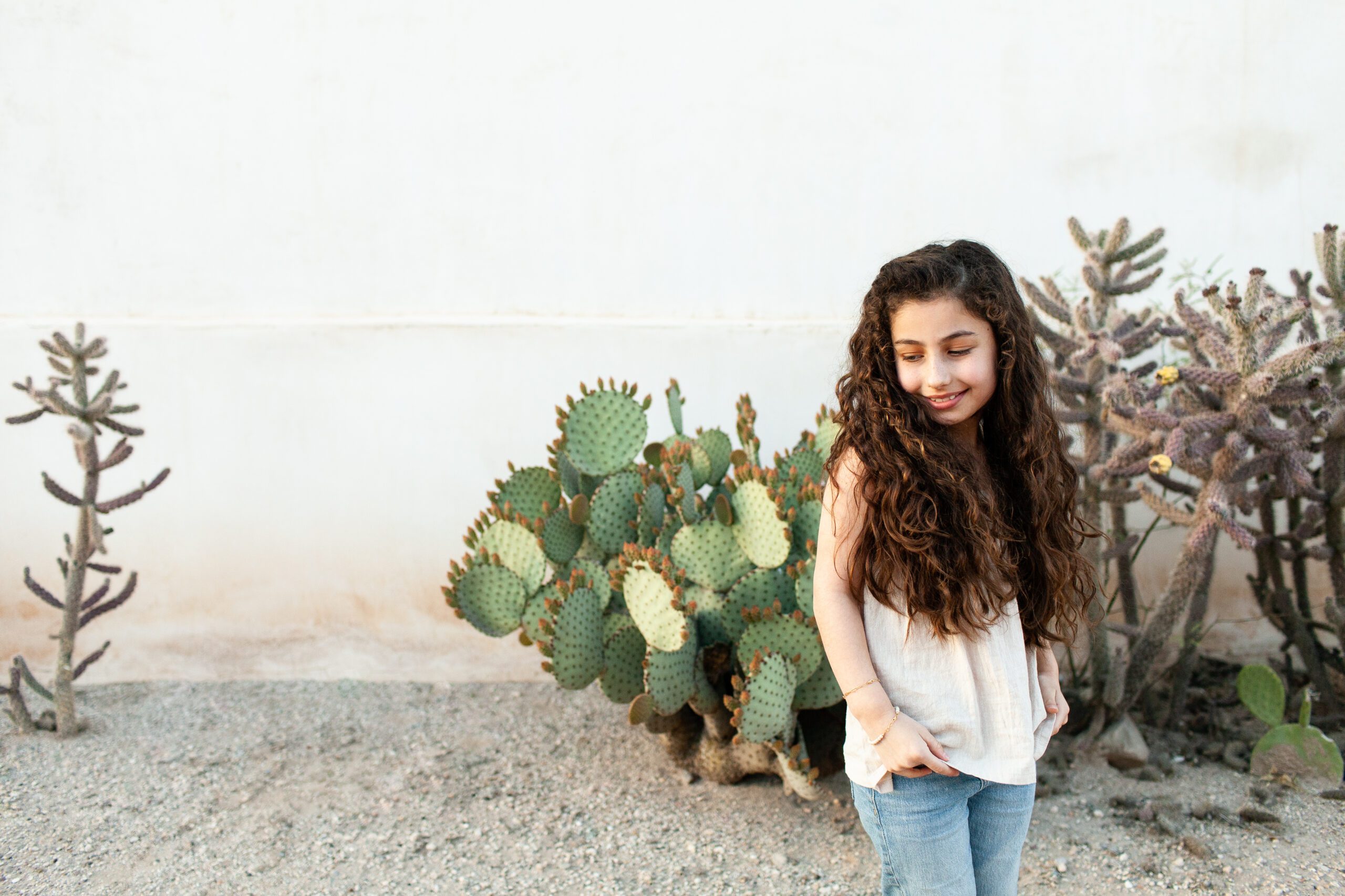 Modern portrait of nine year old girl on her birthday in Barrio Viejo with cacti