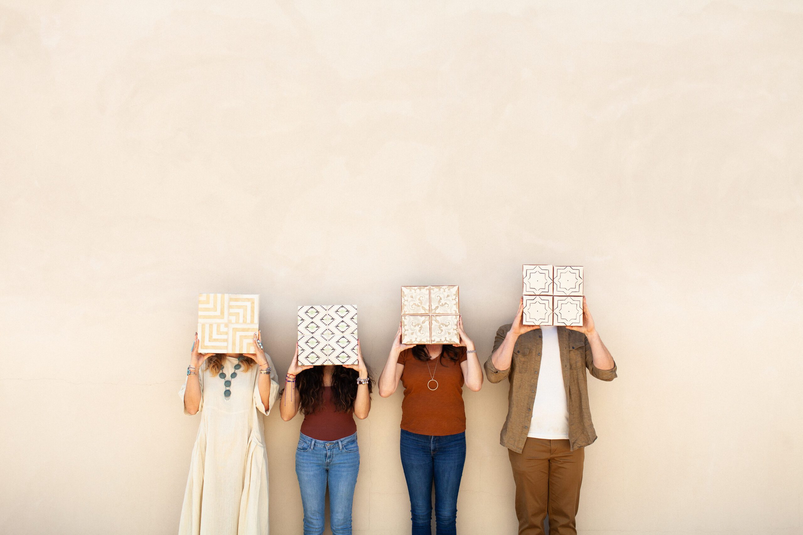 Branding photography for Artesana Tile Shop Tucson, owners and team members holding up one of a kind tiles