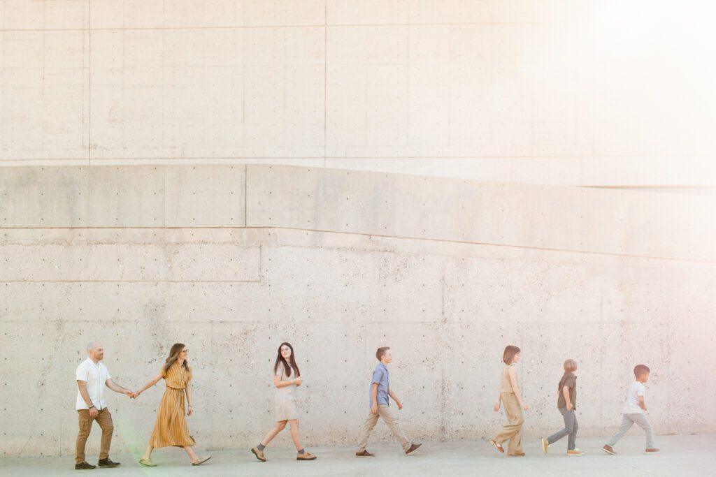 Family of seven walking during their modern architectural portraits in Tucson, Arizona