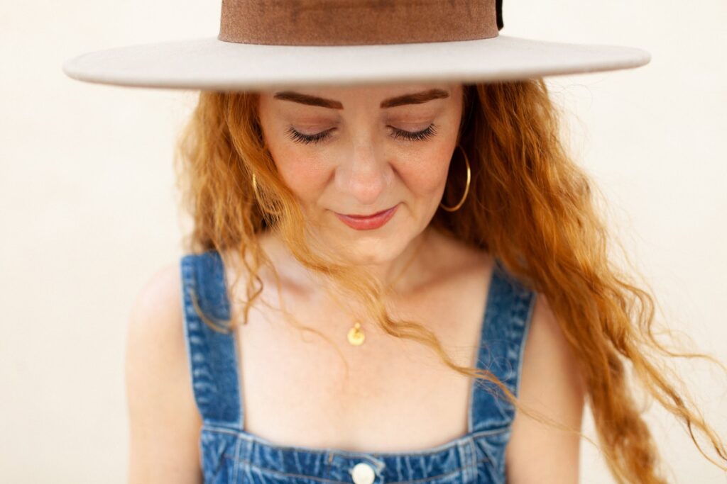 Desert headshots with female art director wearing a fedora hat
