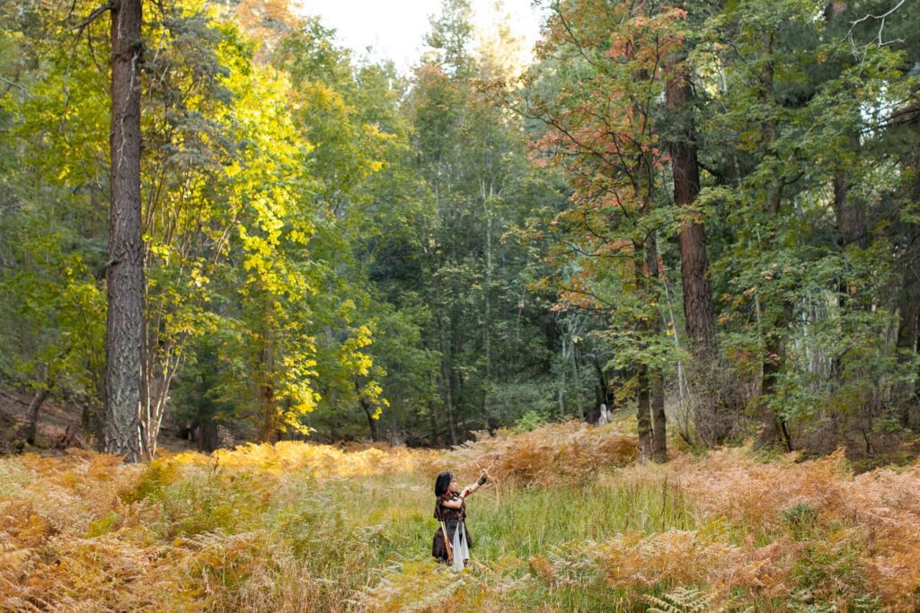 Halloween costume viking mountain explorer photoshoot in a field of trees on Mount Lemmon