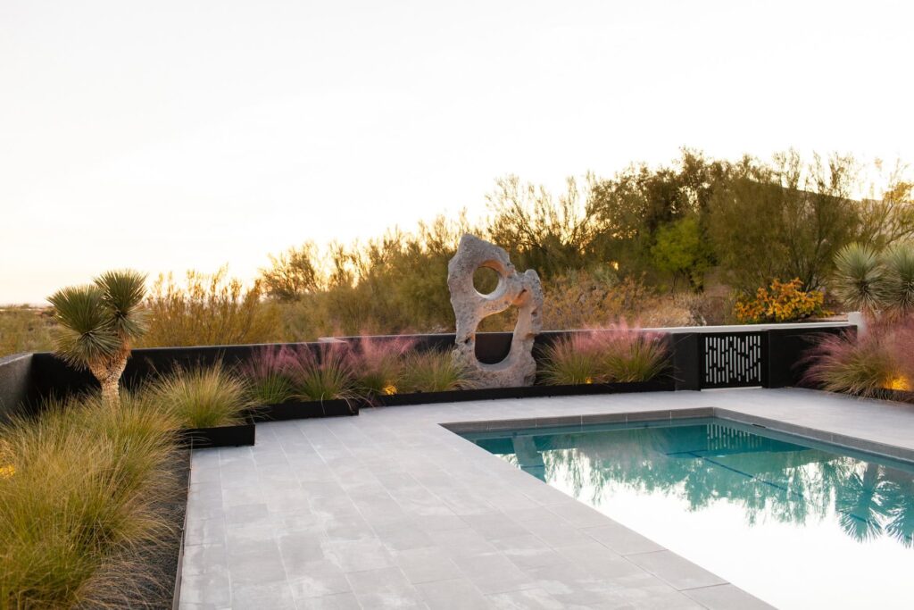 Custom metal gates providing sculptural contrast at a mid-century Tucson home, photographed by Fletcher and Co for Box Hill Landscape Design.