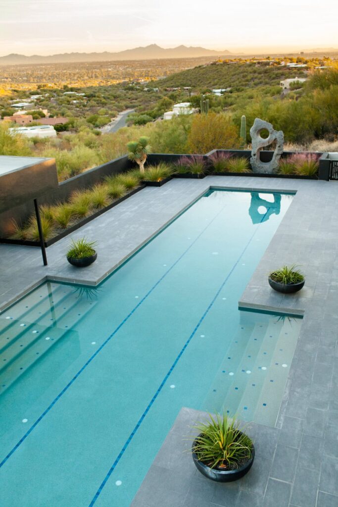 Olympic-length pool with new tile work at a mid-century private home in Tucson’s Catalina Foothills, photographed by Fletcher and Co for Box Hill Landscape Design.