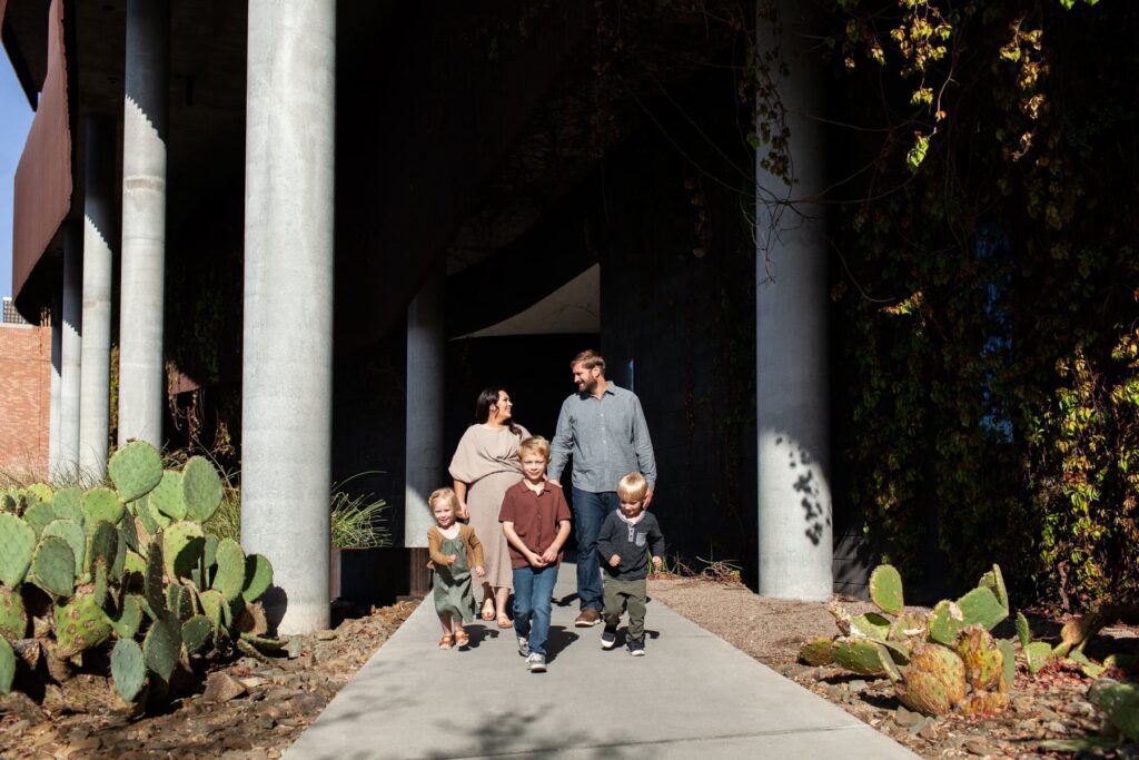 Family of five walking and exploring together at at their architectural family portrait session
