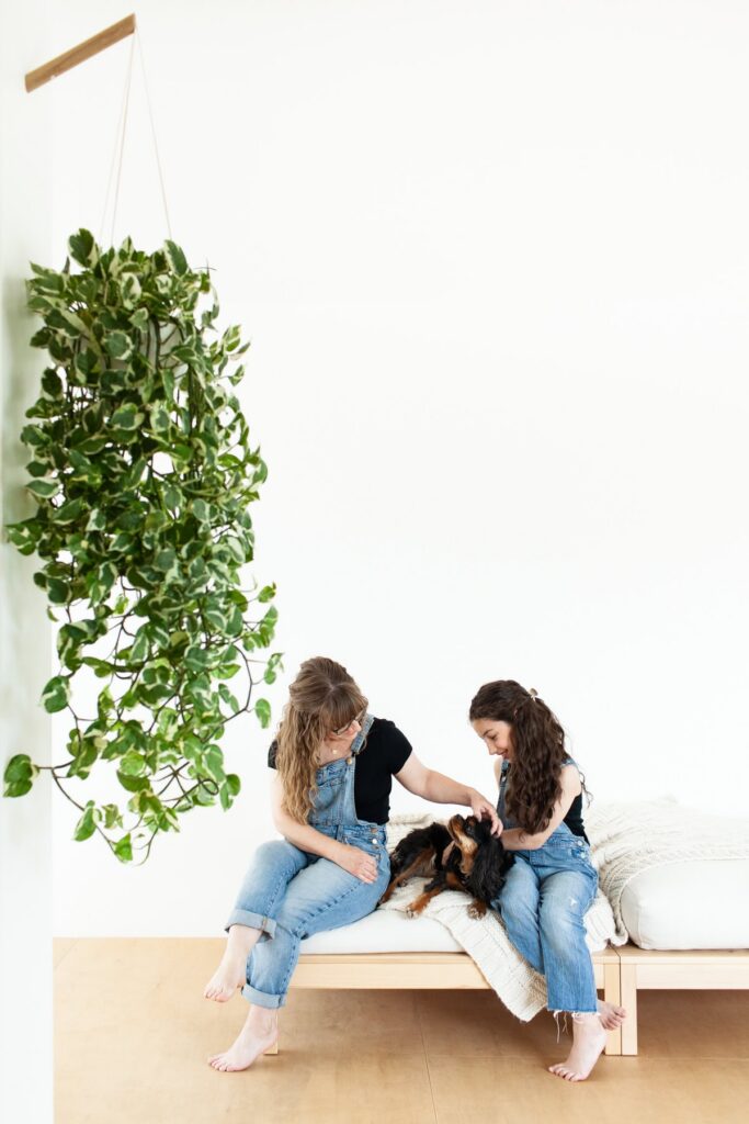 Mother sitting next to her daughter and dog during a modern motherhood photography session in Tucson, Arizona.
