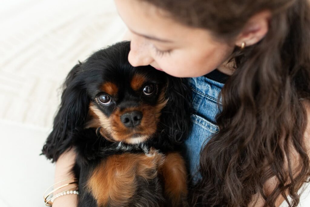 Child hugging and snuggling her dog during a modern portrait photography session in Tucson, Arizona.