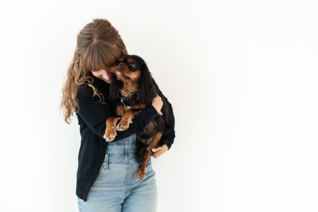 Mother hugging her dog during a modern portrait photography session in Tucson, Arizona.