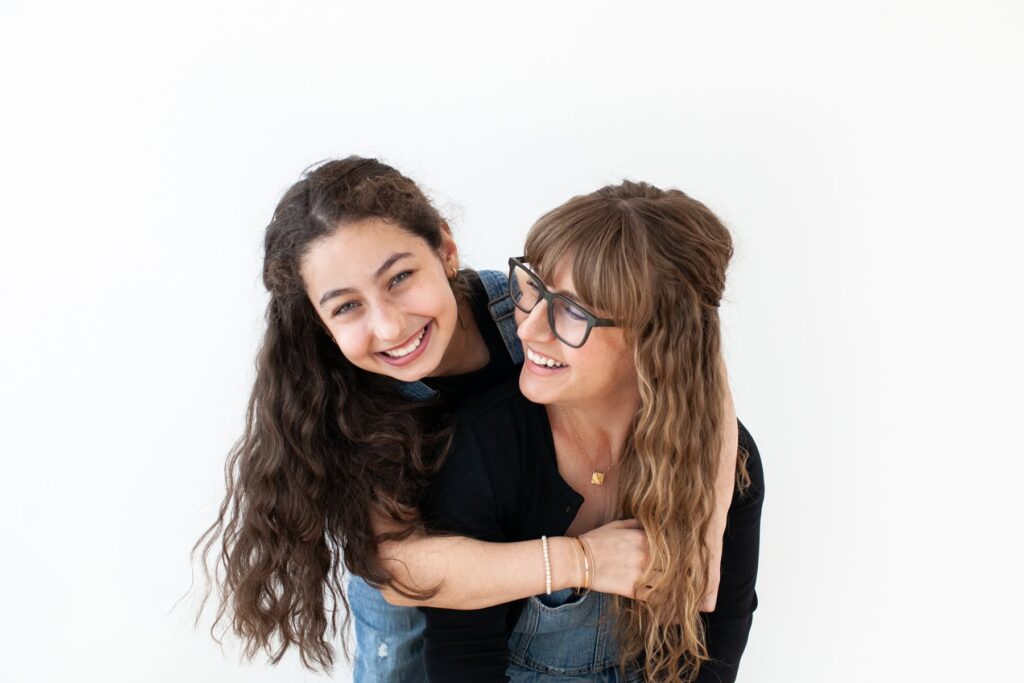 Daughter hugging her mother during a candid studio motherhood photography session in Tucson, Arizona.