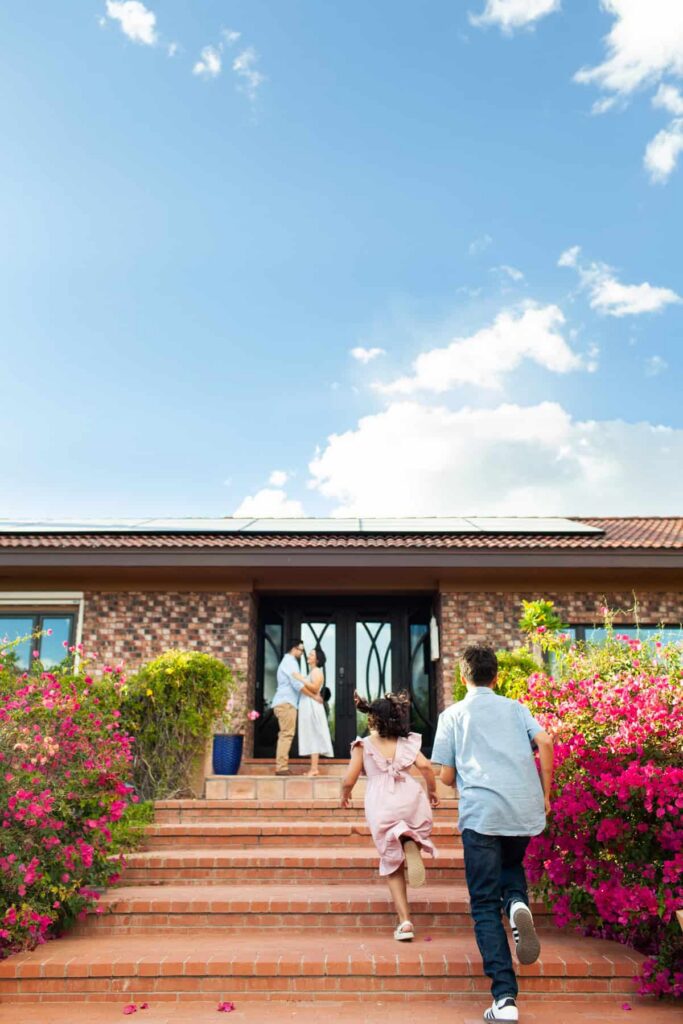 Tucson family photography session captured on their front entryway stairs with the children running up to the parents