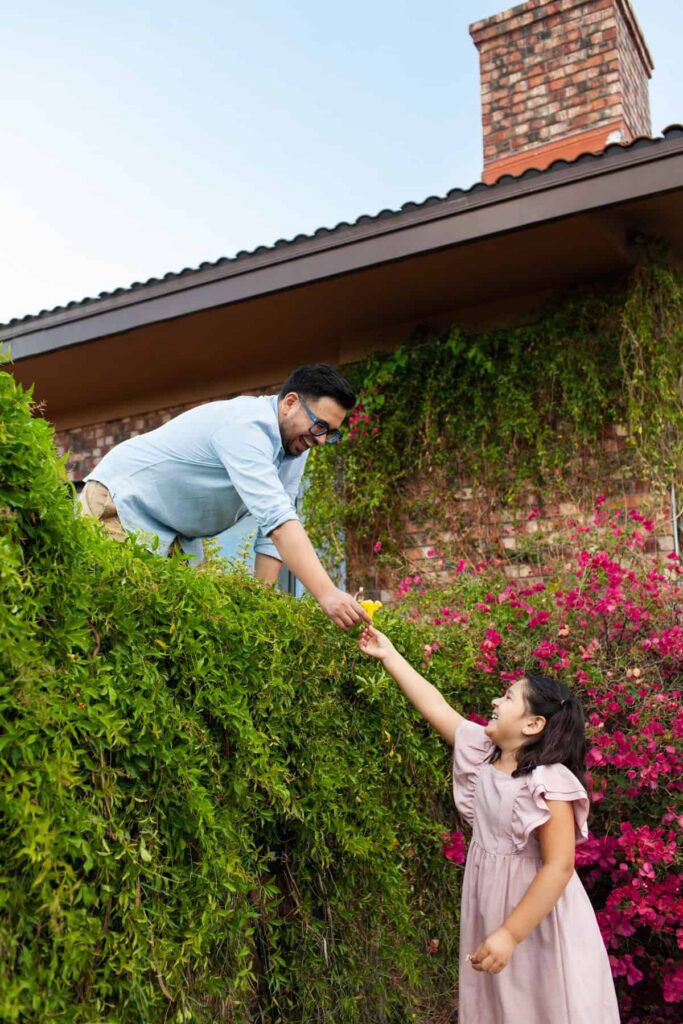 Tucson family photography session where the daughter is handing her father a desert flower bloom