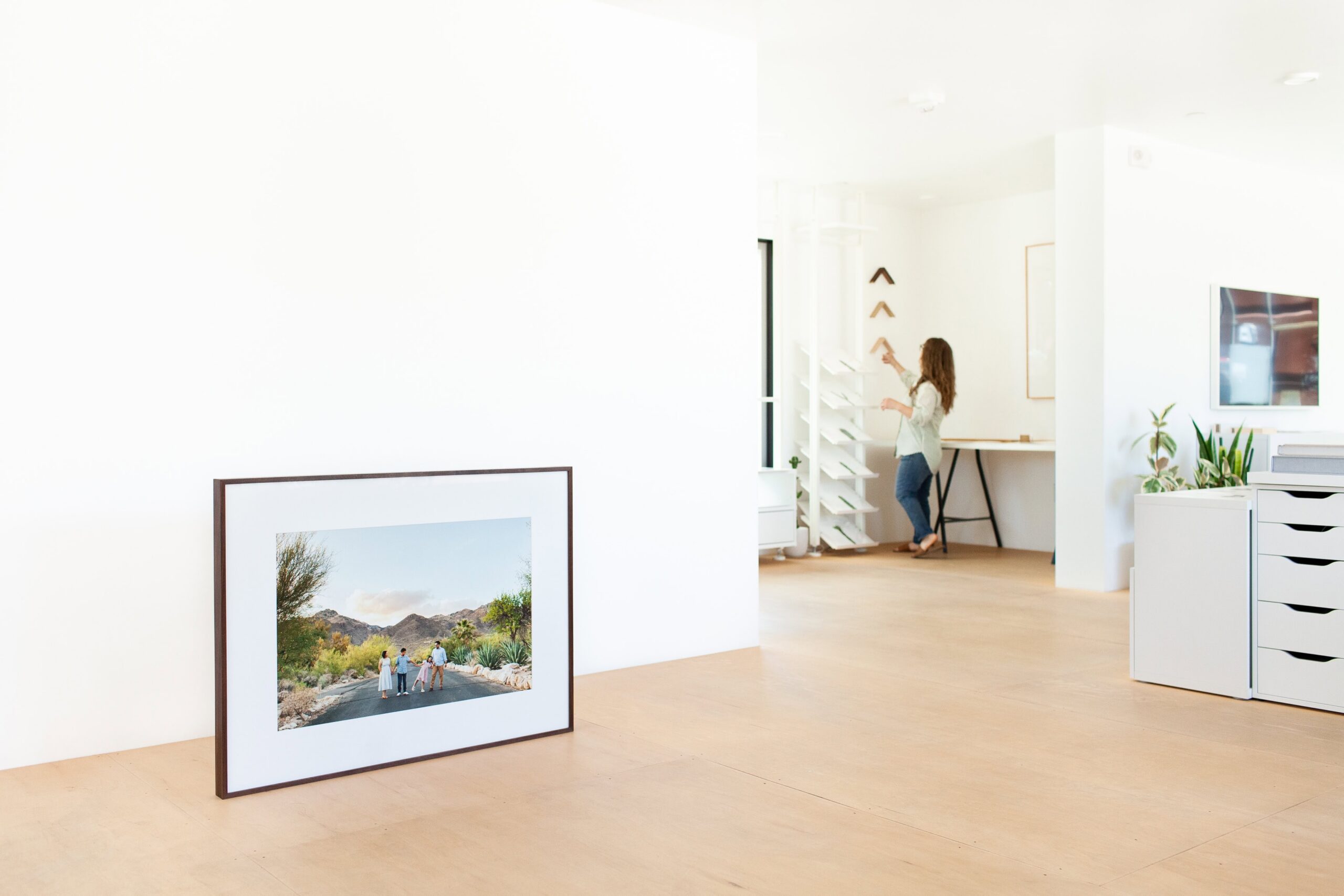 Framed heirloom family portrait displayed in Tucson photography studio with natural walnut frame and museum glass
