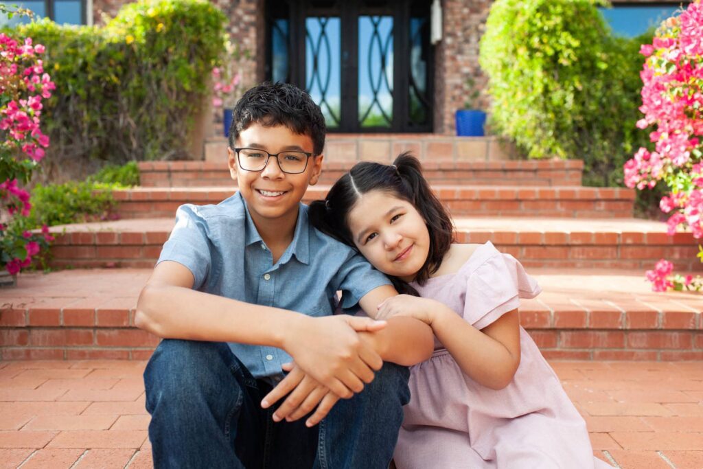 Close emotional moment between two siblings looking at the camera during luxury family photo session in Tucson Arizona